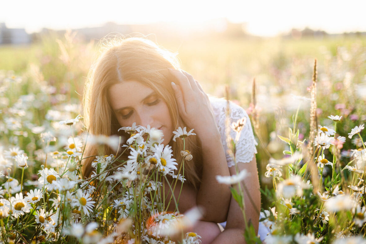 Single portrait of a woman in daisies field, Zurich, Switzerland